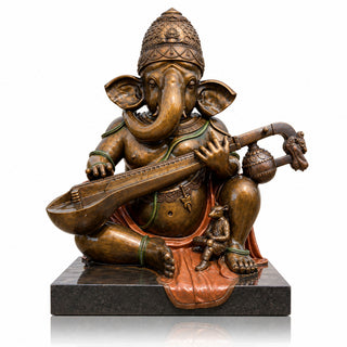 Antique bronze Ganesha statue seated and playing a Indian veena in a traditional Hindu temple courtyard. VSB-170