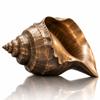 Outdoor bronze seashell statue displayed at a luxury hotel entrance courtyard with modern architectural surroundings.