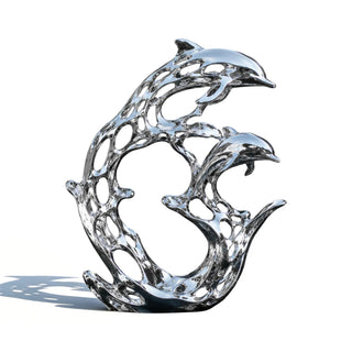 Large stainless steel dolphin sculpture with mirror polished finish installed in a luxury outdoor water feature.