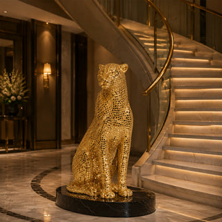 Gold stainless steel leopard sculpture displayed on a luxury console table in a modern home interior