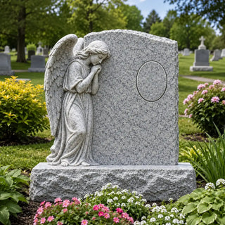 Granite angel headstone with praying angel sculpture and custom portrait area for a cemetery memorial