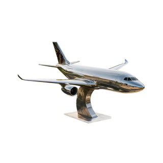 Mirror-polished stainless steel airplane sculpture for an outdoor park as a modern metal landmark.