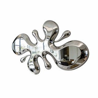 Abstract liquid metal wall sculpture installed in modern living room interior design