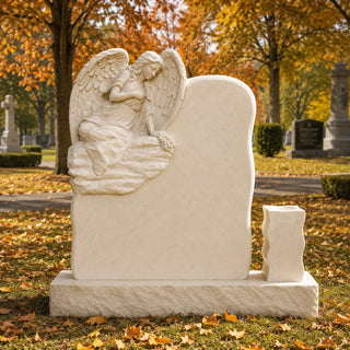 Marble angel memorial with carved flower bouquet, detailed wings and warm beige natural stone craftsmanship