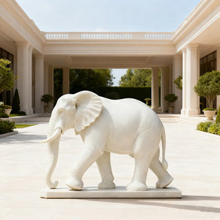 Hand-carved marble elephant sculpture standing at a park as a guardian animal for outdoor decor.