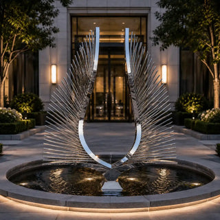 Large monumental double wing stainless steel sculpture installed in a modern city plaza