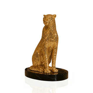Gold stainless steel leopard sculpture displayed on a luxury console table in a modern home interior