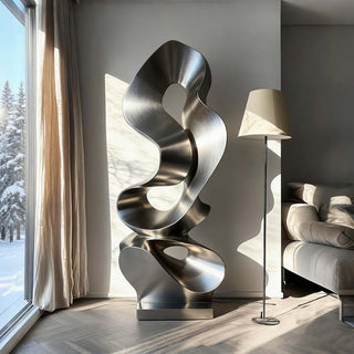 Modern stainless steel sculpture displayed in a luxury interior space, contemporary abstract metal artwork for home decor