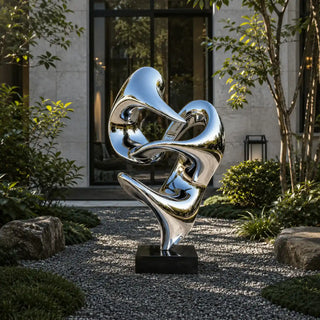 Modern abstract stainless steel sculpture in a garden landscape, outdoor metal art.