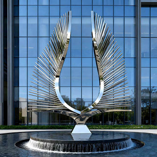 Large monumental double wing stainless steel sculpture installed in a modern city plaza as contemporary outdoor artwork