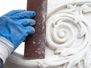 Polishing the marble sculpture surface to achieve a glossy and refined finish, enhancing texture and brilliance of the final artwork