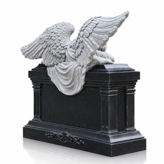 Weeping angel headstone with detailed gray stone wings and a polished black marble memorial base