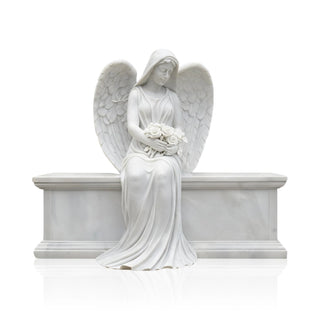 The gravestone angel remembrance marble statue situated in a landscaped garden as a tribute.