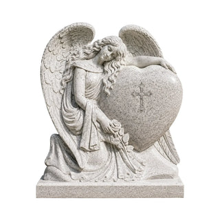 Weeping angel heart gravestone displayed as a personalized Sesame White granite memorial in cemetery